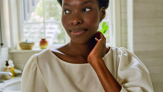 A woman taking a quiet moment to consider recurring intimate symptoms