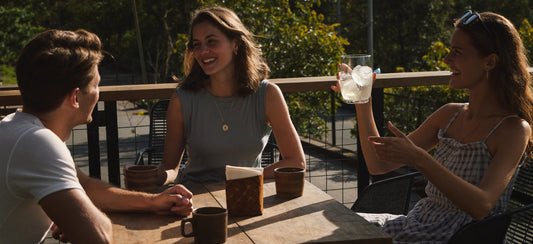 Young adults enjoying a relaxed outdoor cafe conversation