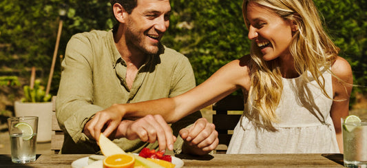 Young adult friends sharing a relaxed outdoor brunch in the sunshine.