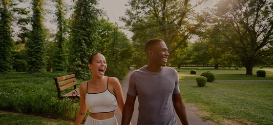 Two friends enjoying a walk together in a leafy park