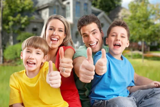 Happy family outdoors giving thumbs up, symbolizing improved allergies and quality of life