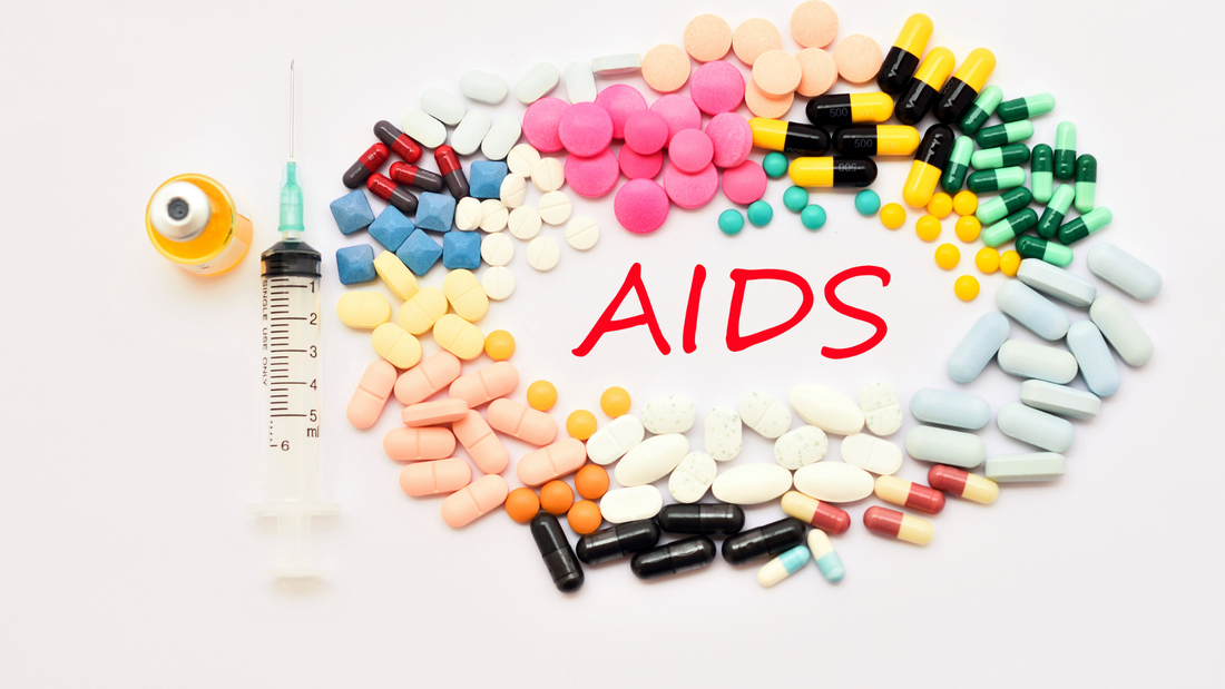 Colorful pills arranged around the word AIDS with a syringe and vial, representing AIDS education and treatment options