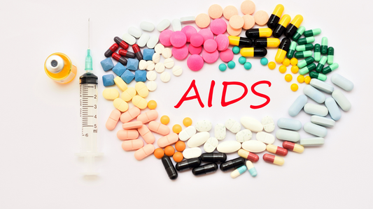 Colorful pills arranged around the word AIDS with a syringe and vial, representing AIDS education and treatment options