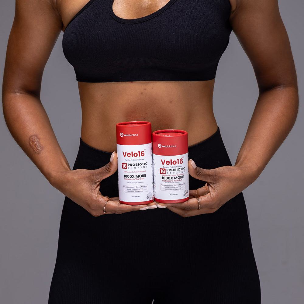 Velo16 Probiotic Capsules for digestive health and immunity boost held by person in black sportswear