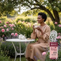 Woman enjoying tea in a garden with Her-Biotics Probiotics Menopause Support supplement for hormonal balance and vitality